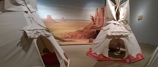 Hier wäre ein Bild aus einer Ausstellung für Kinder mit nachgebauten Tipis, wie sie die Ureinwohner Nordamerikas gebaut haben.